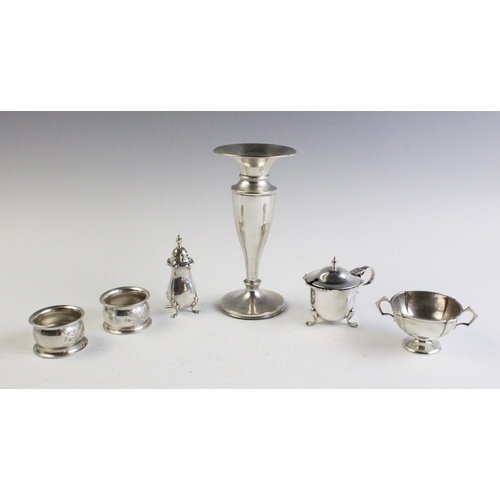 32 - A selection of silver tableware, to include, an Edwardian weighted silver posy vase, Chester 1901, a... 