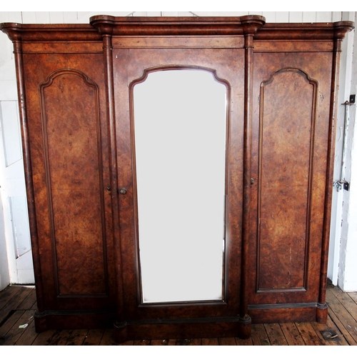 869 - A Victorian burr walnut breakfront triple wardrobe, the stepped cavetto cornice above a central mirr... 