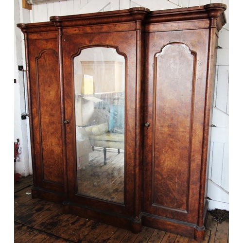 869 - A Victorian burr walnut breakfront triple wardrobe, the stepped cavetto cornice above a central mirr... 