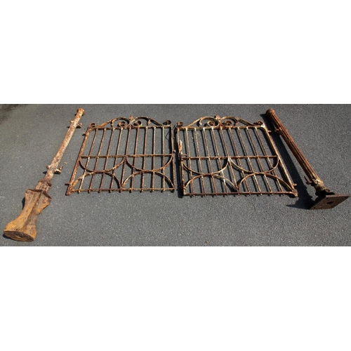 910 - A pair of 19th century wrought iron gates and two gate posts, each gate with a spear finial above sc... 