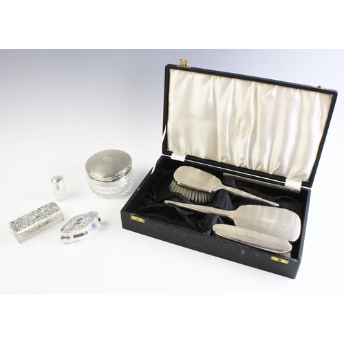 56 - A selection of silver dressing table wares, to include a silver mounted part dressing table set by A... 