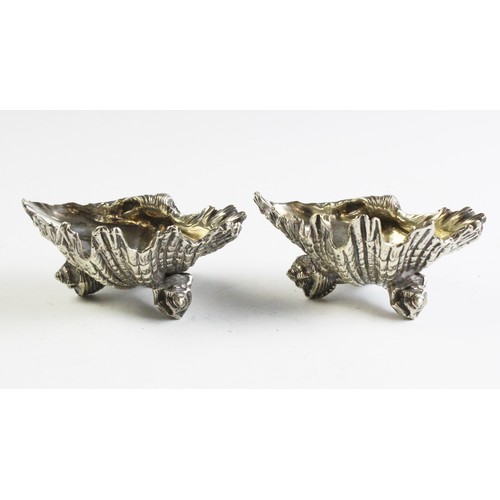 68 - A pair of silver plated shell shaped salts, possibly Elkington & Co, one stamped 'GS', each 11.8cm w... 