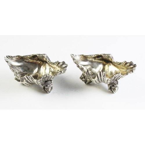 68 - A pair of silver plated shell shaped salts, possibly Elkington & Co, one stamped 'GS', each 11.8cm w... 