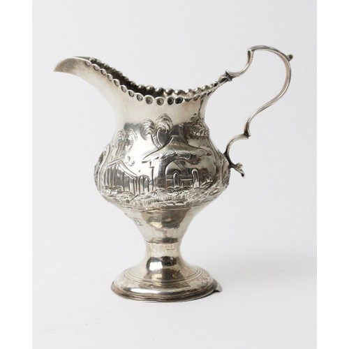 47 - A Georgian silver cream jug by Hester Bateman, London 1780, of baluster form on circular domed foot,... 