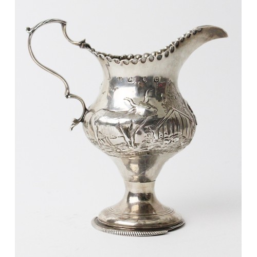 47 - A Georgian silver cream jug by Hester Bateman, London 1780, of baluster form on circular domed foot,... 