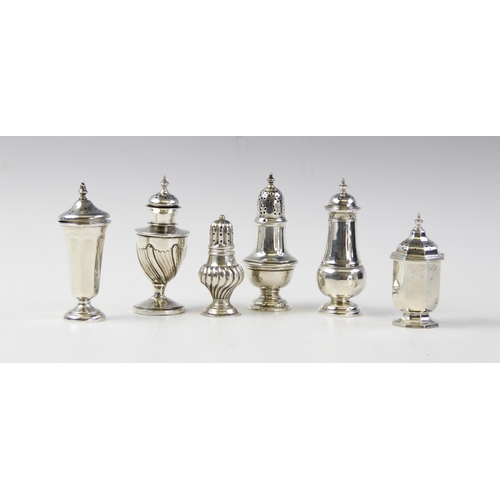 131 - A silver pepperette by Walker & Hall, Sheffield 1913, of urn form on pedestal foot with half-reeded ... 