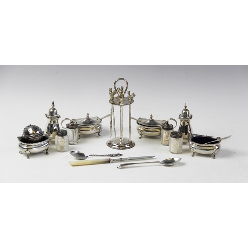 134 - An Edwardian silver cruet set by Levesley Brothers, Sheffield 1906, comprising two salts, two wet mu... 