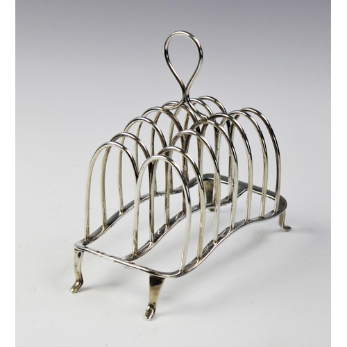 63 - An Edwardian six division silver toast rack by William Hutton & Sons, London 1906, with loop handle ... 