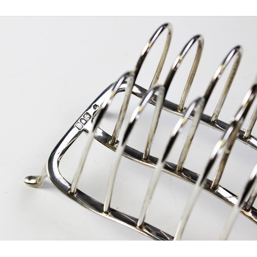 63 - An Edwardian six division silver toast rack by William Hutton & Sons, London 1906, with loop handle ... 