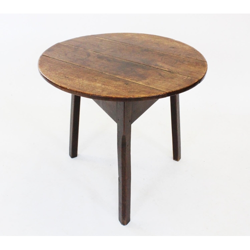 678 - A late 18th century oak cricket table, the circular four plank top top raised upon three chamfered l... 