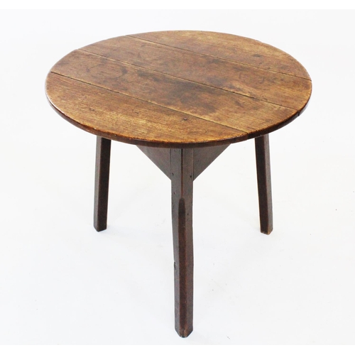 678 - A late 18th century oak cricket table, the circular four plank top top raised upon three chamfered l... 