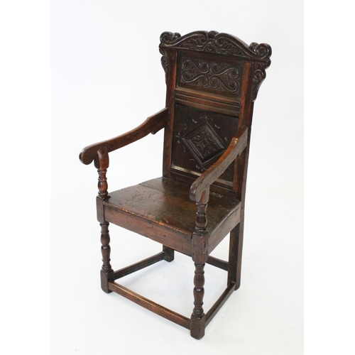 682 - A 17th century and later oak Wainscot chair, the carved pediment with scroll terminals above a panel... 