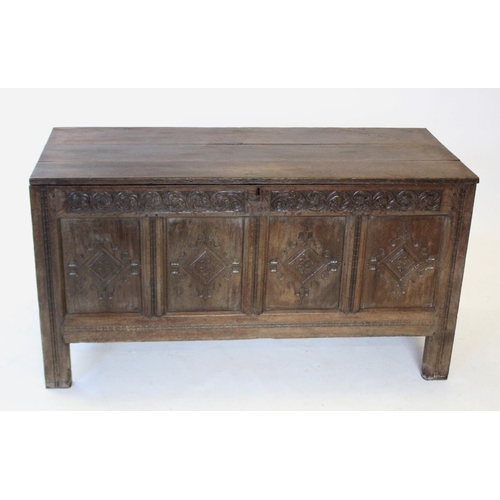 686 - An early 17th century oak coffer, the hinged plank cover carved 'ER 1705', enclosing a fitted candle... 