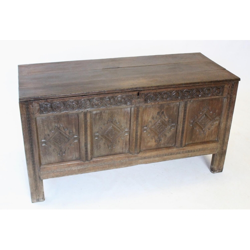 686 - An early 17th century oak coffer, the hinged plank cover carved 'ER 1705', enclosing a fitted candle... 