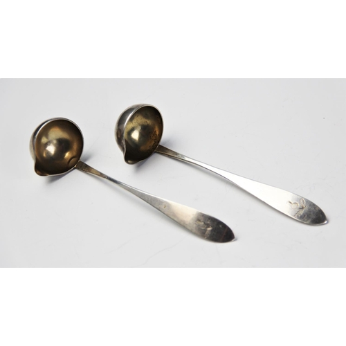 70 - A pair of 19th century continental silver cream ladles, the handles engraved with thistles, stamped ... 