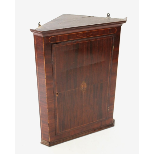 705 - A George III mahogany straight front hanging corner cupboard, the single door centred with an inlaid... 