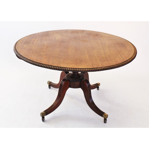 708 - A Regency mahogany centre table, the circular top with gadrooned border, raised upon a ring turned p... 