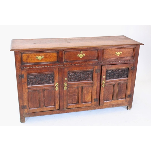 711 - A 19th century oak dresser base/sideboard, the rectangular thumb moulded top above three invert moul... 