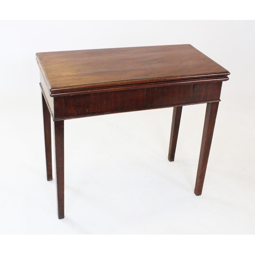 712 - An early 19th century mahogany folding tea table, the rectangular top above a plain frieze, raised u... 