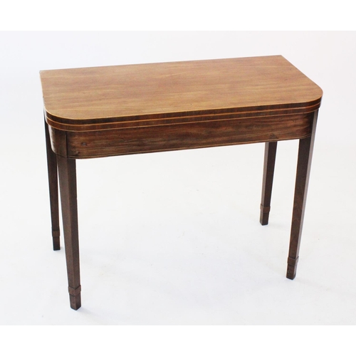 713 - An early 19th century mahogany folding tea table, the 'D' shaped top outlined with inlaid stringing,... 