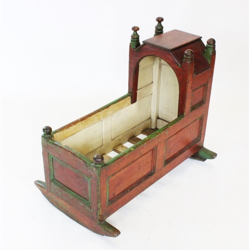 722 - A Victorian painted pine cradle, the angular canopy flanked by turned finials above invert panelled ... 