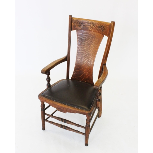 723 - A late 19th century oak country elbow chair, the concave top rail with incised detail above a shaped... 