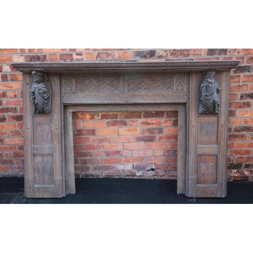 731 - A 17th century style carved oak fire surround, 19th century, the rectangular shelf above panels carv... 