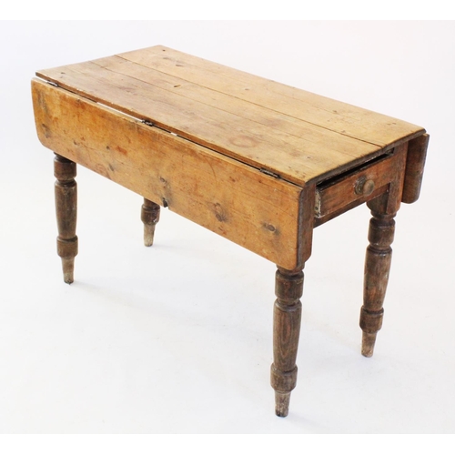 739 - A Victorian pine drop leaf kitchen table, with a single frieze drawer, raised upon turned tapering l... 