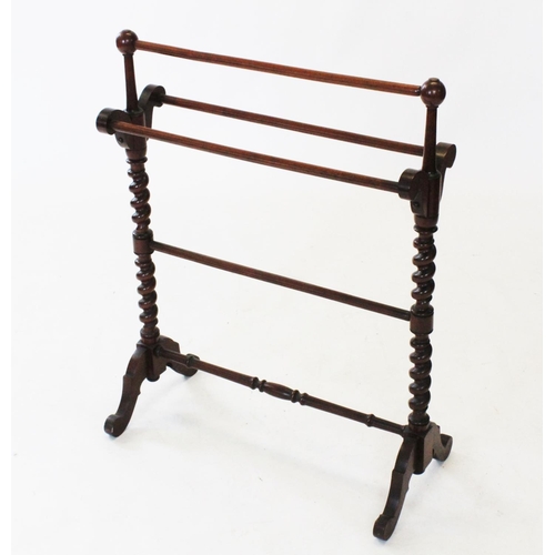 743 - A Victorian mahogany towel rail, with spherical finials upon barley twist uprights and down swept su... 