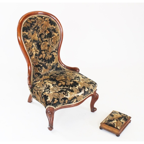 744 - A Victorian mahogany framed balloon back nursing chair, covered in embossed foliate fabric with a se... 