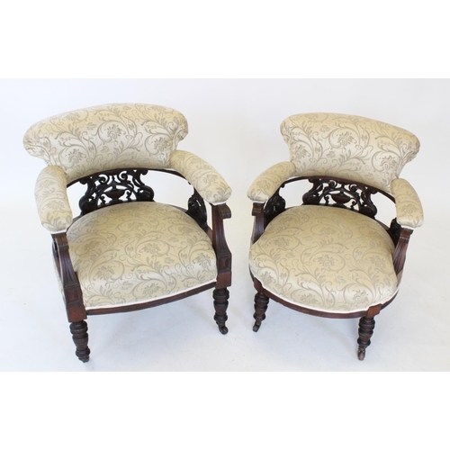 746 - A pair of Victorian ladies and gents walnut and upholstered tub chairs, each with a padded back and ... 