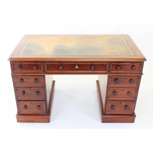 750 - A Victorian mahogany twin pedestal desk, the rectangular moulded top inset with a gilt tooled green ... 