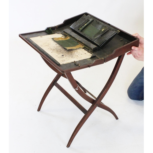 751 - A 19th century mahogany campaign folding writing table, with an enclosed leather stationery interior... 