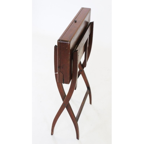 751 - A 19th century mahogany campaign folding writing table, with an enclosed leather stationery interior... 