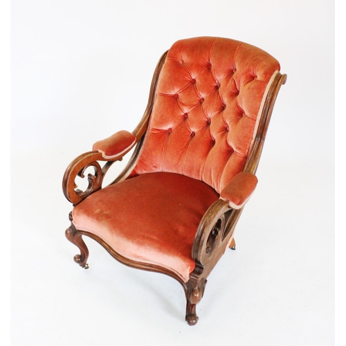 757 - A mid 19th century mahogany framed open armchair, the padded button back flanked by channelled down ... 