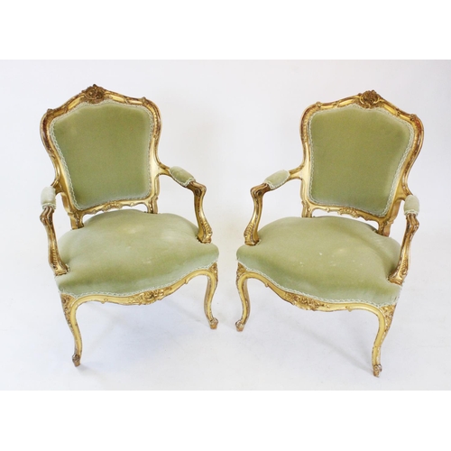 761 - A pair of French Louis XV style gilt wood fauteuil, late 19th century, each with a carved scrolling ... 