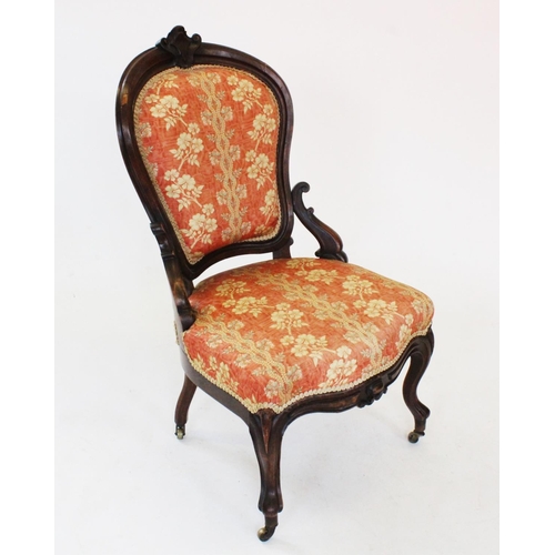 762 - A Victorian walnut ladies chair, the shaped padded back rest with a carved shield shaped crest, abov... 