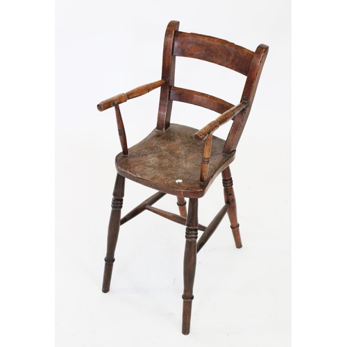 763 - A Victorian child's elm and beech correction chair, the shaped elm seat flanked by turned arms and r... 