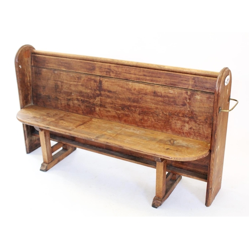 775 - A Victorian pitch pine church pew, with moulded arched end supports enclosing the board seat and bac... 