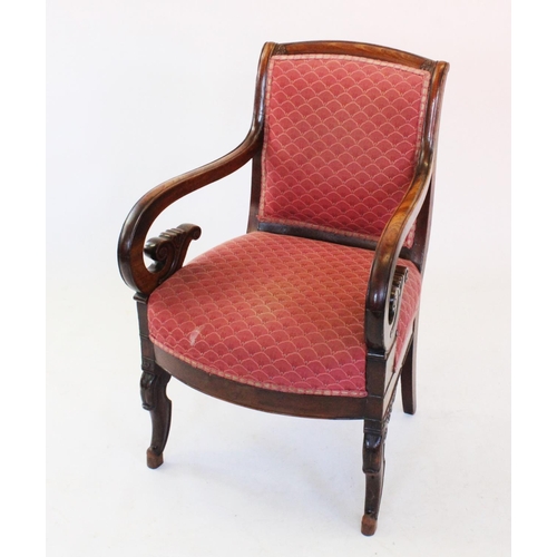 778 - A William IV mahogany open library armchair, with a padded back rest above down swept arms terminati... 