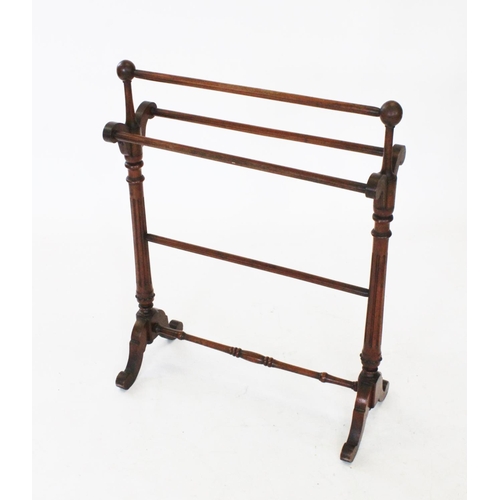 791 - A Victorian mahogany Gothic influence towel rail, with spherical shaped finials upon fluted and tape... 