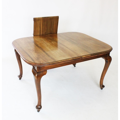 794 - An early 20th century walnut dining table, the rectangular top with rounded corners, raised upon cab... 