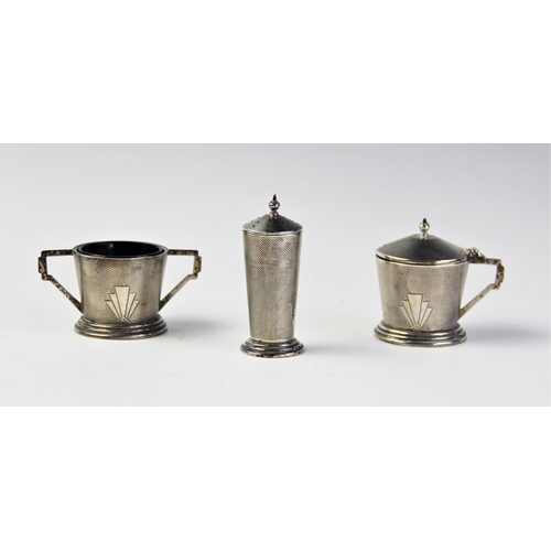 81 - A silver Art Deco style cruet set by William Suckling Ltd, Birmingham 1940, comprising wet mustard, ... 