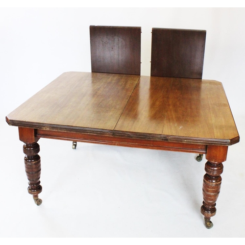 813 - An Edwardian mahogany extending dining table, the rectangular top with canted corners, raised upon r... 