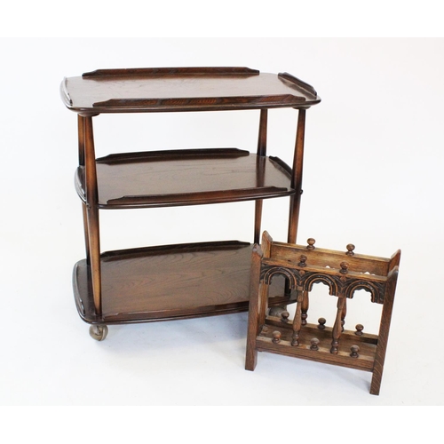 818 - An Ercol elm three tier tea trolley, the three galleried tiers raised upon tapering supports and she... 