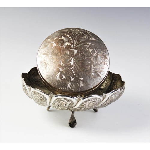 82 - A Persian white metal tripod bowl, of circular scalloped form on three feet, with engraved and embos... 