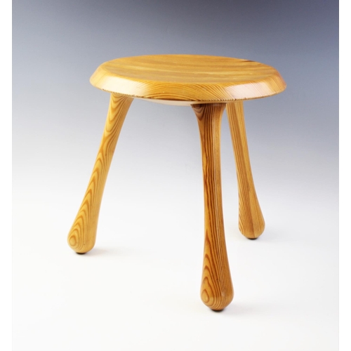 820 - A pine lacquered three legged milking stool, designed by IKEA founder Ingvar Kamprad for the Habitat... 