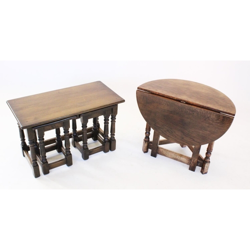 823 - A reproduction oak nest of three tea tables, raised upon turned baluster and block supports united b... 