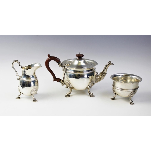 92 - An Edwardian three piece silver tea service by Wakely & Wheeler, London 1906, comprising a teapot, s... 