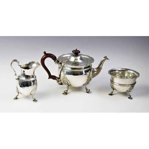 92 - An Edwardian three piece silver tea service by Wakely & Wheeler, London 1906, comprising a teapot, s... 